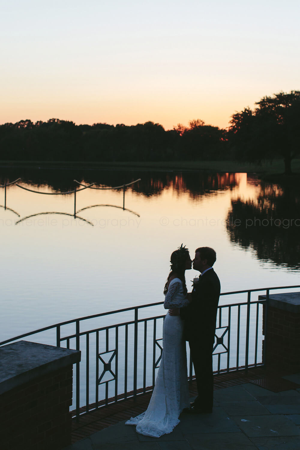 bride and groom kiss at sunset at montgomery museum of fine arts