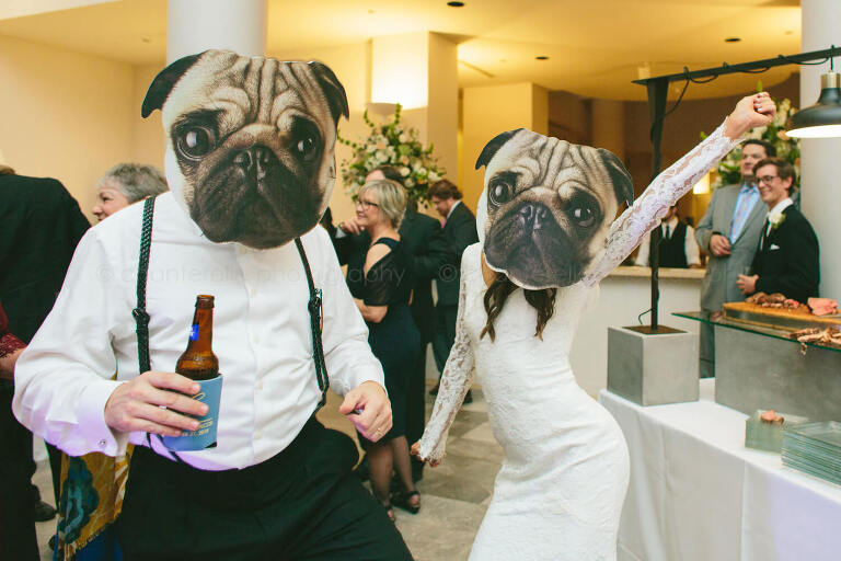 bride and groom wearing pug masks