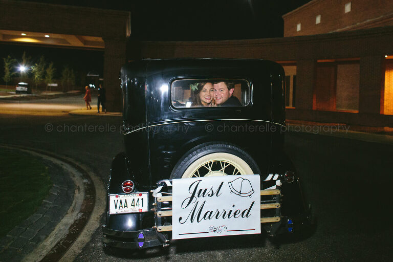 bride and groom's grand exit in vintage car