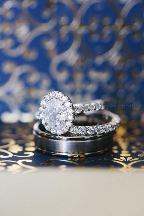 diamond wedding rings on navy and gold background