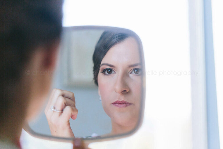 bride checking makeup in mirror
