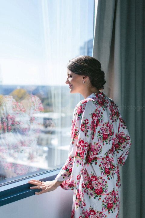 bride looking out hotel room window in atlanta