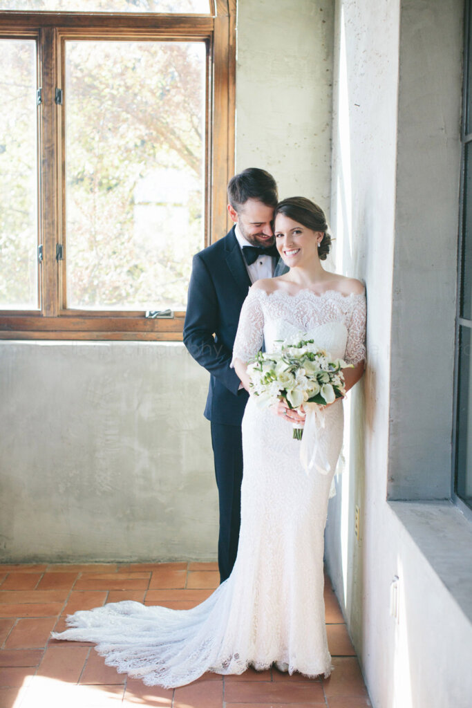bride and and groom snuggling at summerour studio