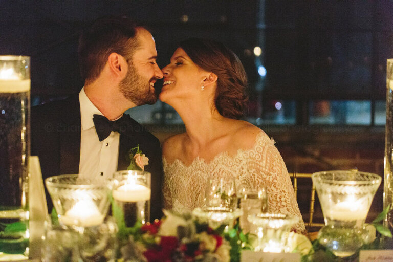 bride and groom kiss and smile at atlanta wedding reception