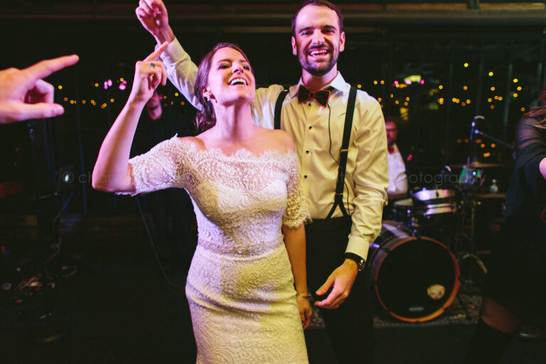 bride and groom dance on stage at atlanta wedding reception