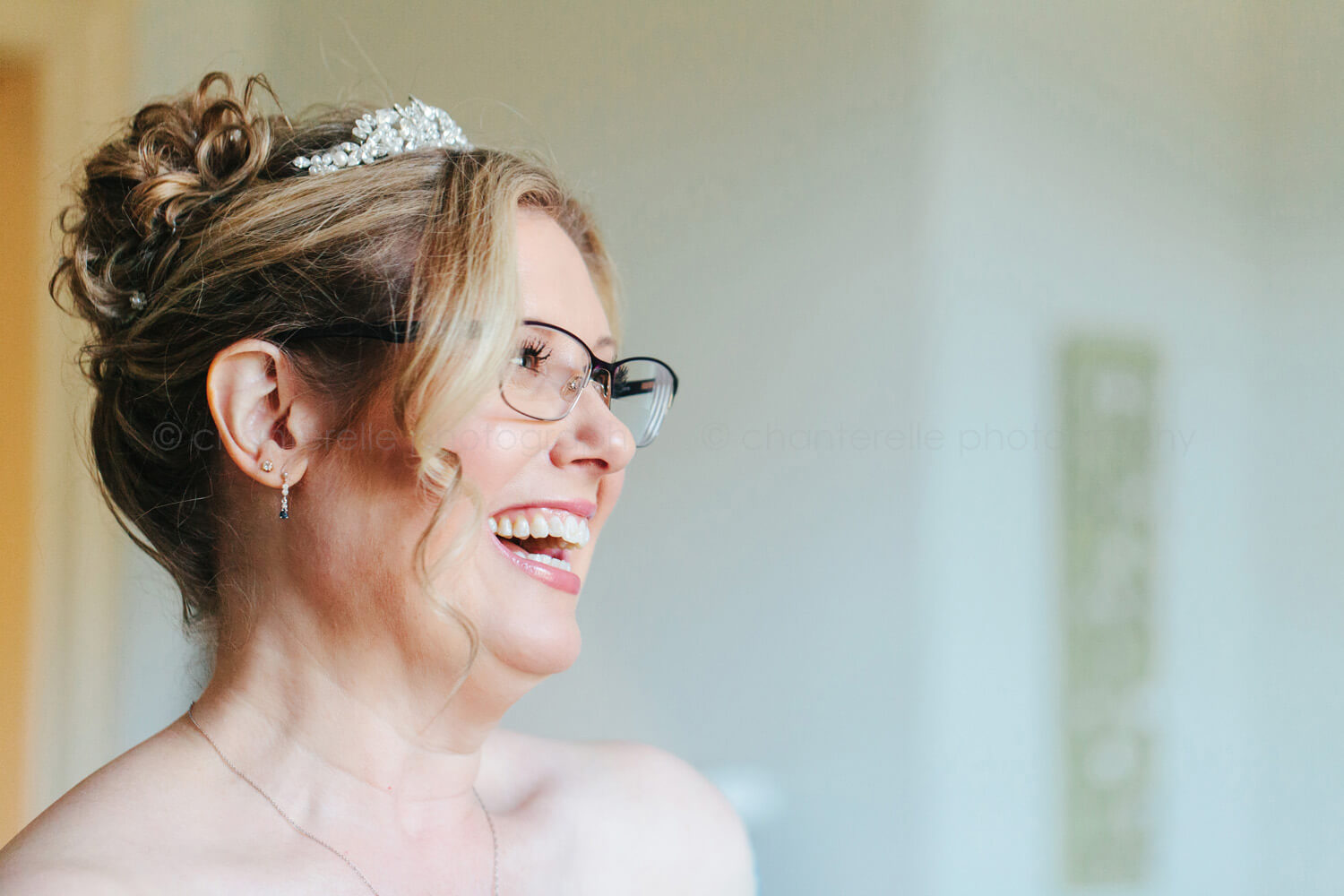 bride in glasses laughing