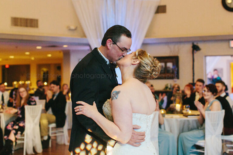 bride and groom kiss during first dance