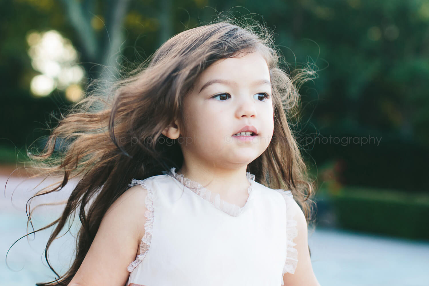 toddler girl with hair blowing in the wind