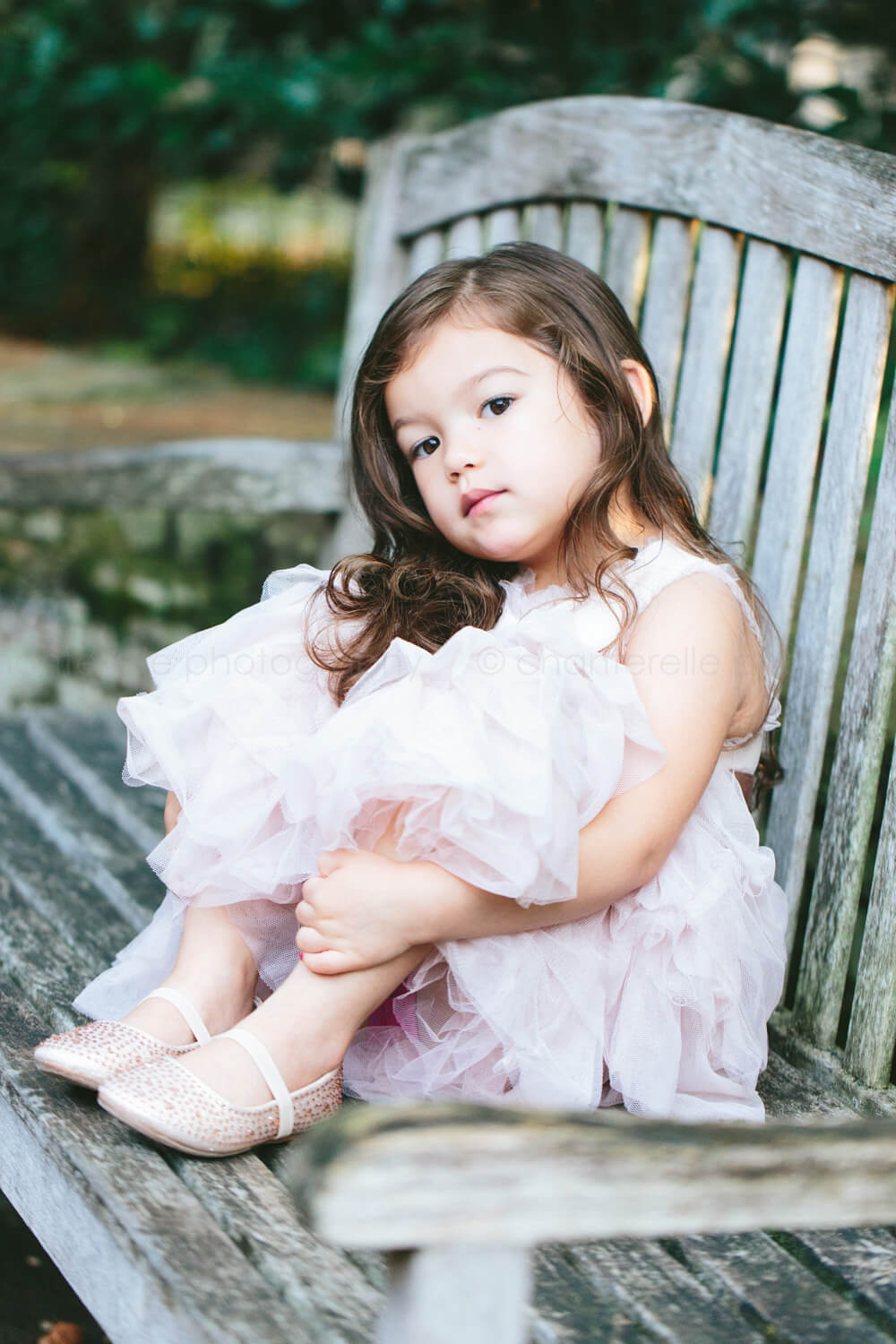toddler girl sitting on bench at blount cultural park