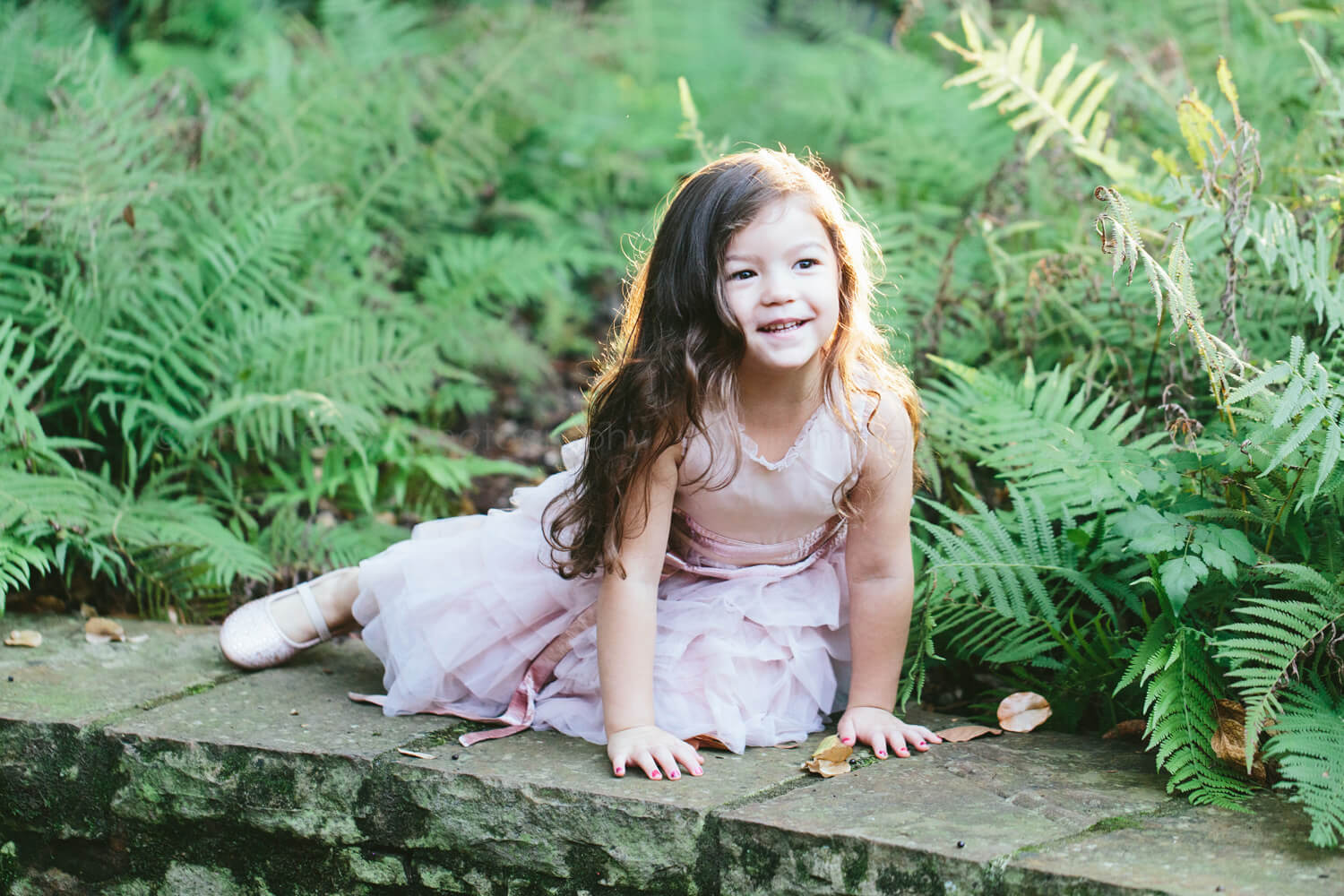 toddler girl in pink dress smiling