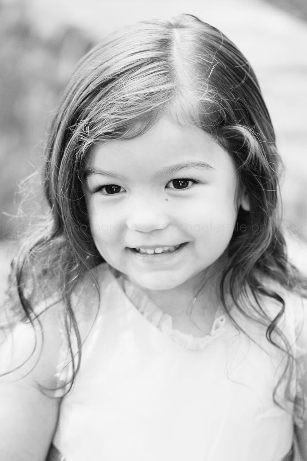 toddler girl smiling in black and white