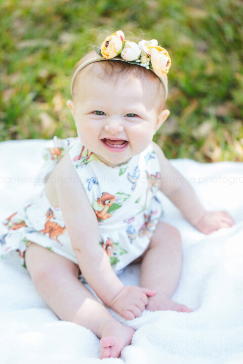 smiling baby girl wearing vintage bambi outfit