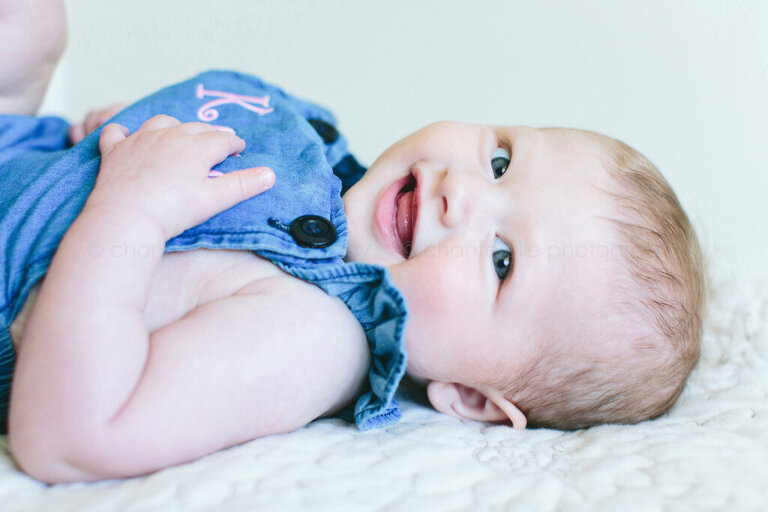 6 month old baby girl smiling for portraits